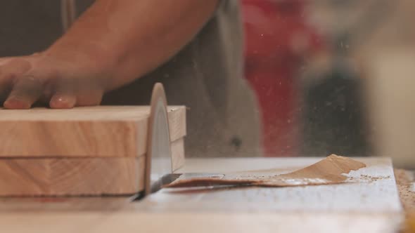 Carpentry Industry - Man Grinding the Side on the Piece of Wood