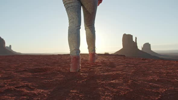 Closeup of Travelers Feet in Pink Outdoor Hiking Boots Walking in Golden Sunset