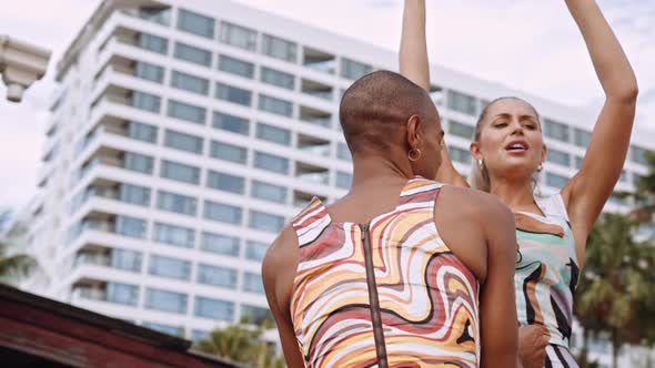 Fashion Models Dancing And Laughing Together In Bright Clothing