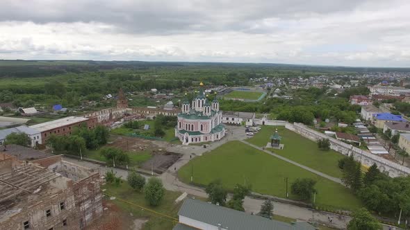 Aerial view big church in monastery surrounded by a brick wall on the edge of the Dalmatovo city 03 alt
