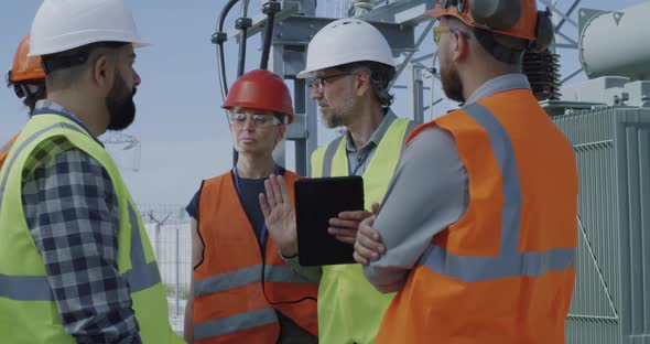 Foreman Explaining Data To Employees on Power Plant