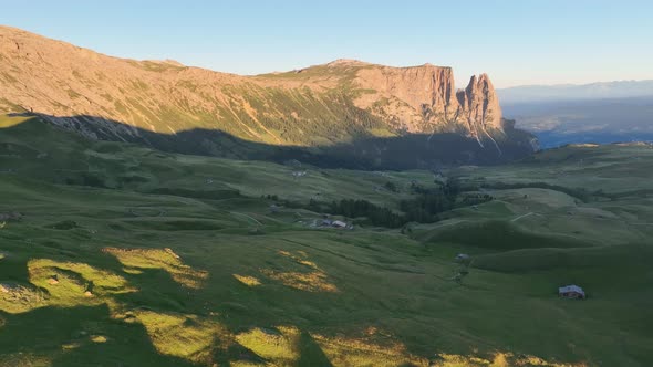 Dolomites mountains peaks with a hiking path on a summer sunrise