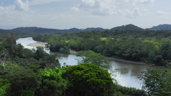 Aerial Drone View of Rainforest River and Mountains Scenery in Costa Rica at Boca Tapada, San Carlos