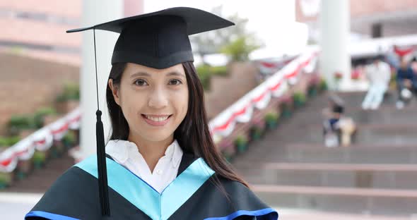 Woman with graduation gown in university gown