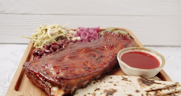 Close Up A Large Plate That Includes Baby Back Ribs with Cherry Chipotle Sauce