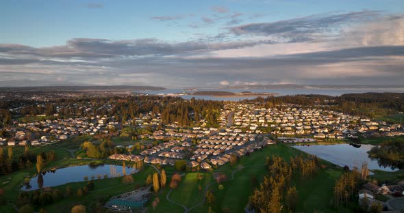 Panning aerial of Oak Harbor's dense neighborhoods at sunset.