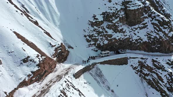 Aerial Shot of Group of Travelers Stuck in the Middle Due To Snow Block Revealing Roads Covered with