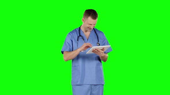 Smiling Doctor Using a Tablet. Green Screen