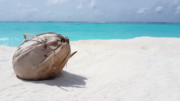 Daytime above tourism shot of a white paradise beach and aqua turquoise water background in 4K