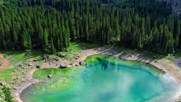 Majestic aerial view of Carezza lake in Dolomites