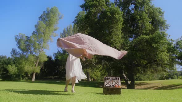 RED Camera Slow Motion Woman Chilling on Blanket on Green Lawn at Summer Park