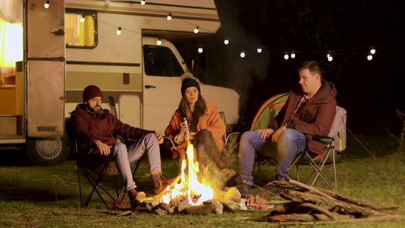 Group of Friends Enjoying a Quiet Moment in Front of the Fire