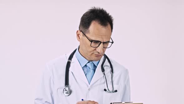 Middle Aged Therapist Carefully Examines Patient’s Medical History and Smiles