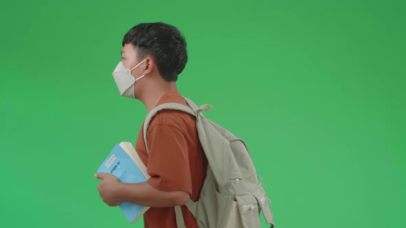 Asian Boy Student Wearing A Mask, Holding A Book While Running To School On Green Screen