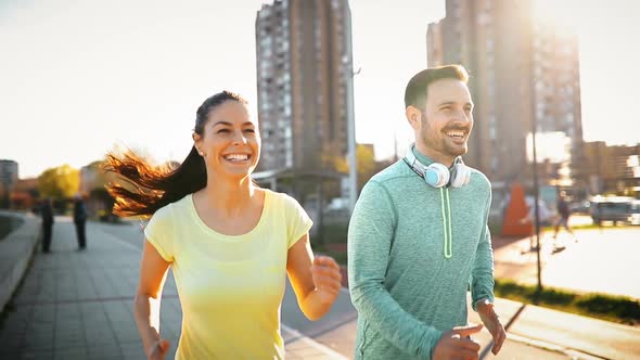 Happy Friends and Sports People Jogging and Running Outdoor