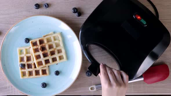 Waffles Being Baked in the Waffle Maker. Savory waffles. Breakfast concept.