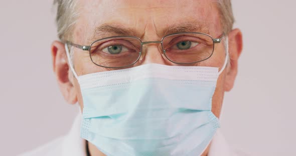 An Elderly Man Puts on His Medical Mask During a Pandemic