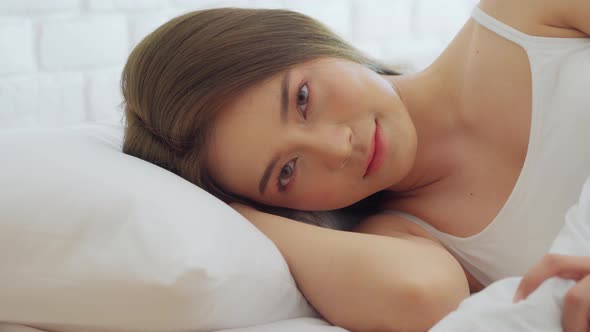 Asian woman wearing Pajamas sleep close her eyes smile sleep and sweet dream