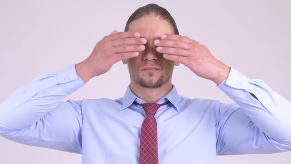 Handsome Businessman Covering Eyes As Three Wise Monkeys Concept