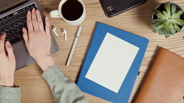 Mockup a Blank Paper Lies on the Desktop of a Young Woman