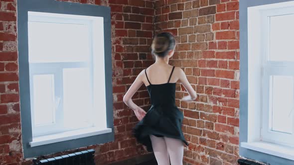 Ballet Dancing Indoors a Little Gymnastics Girl Dancing in Black Suit on Training From the Corner of