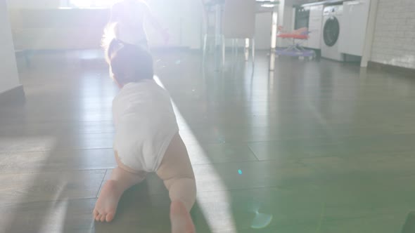 Rear View of a Baby Girl Crawling on Floor Toddler Exploring Home