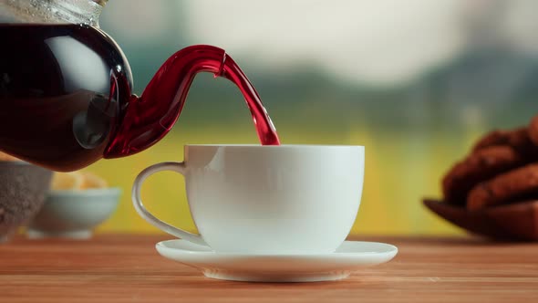 Pouring Red Fruit Tea Into Glass Cup Closeup