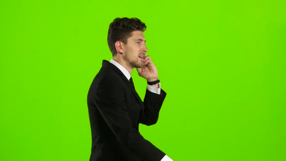 Man Goes To Work and Talks on the Phone. Green Screen. Side View