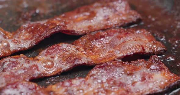 Cook with bacon on fry pan 