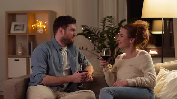 Happy Couple Drinking Red Wine at Home in Evening 6