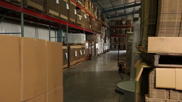 Delivery man moving packages in warehouse