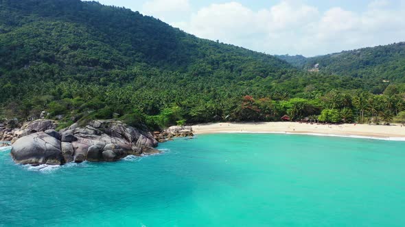 Pristine nature and turquoise water of the lagoon on Koh Phangan. Aerial panorama