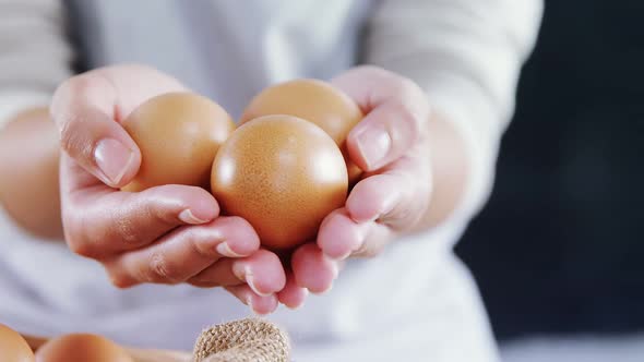 Woman holding brown eggs 4k