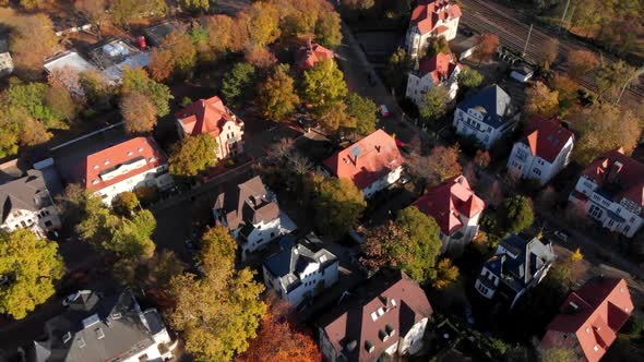 Small village next to railway in Magdeburg Germany, slow ascending aerial