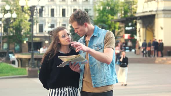 Young Stylish Couple with Map in the City