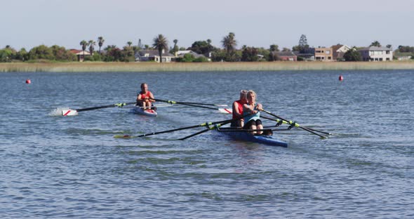 Four senior caucasian men and women rowing boat on a river