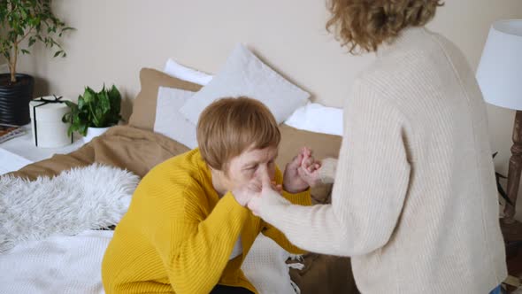 Daughter Helping Her Senior Mother At Home. Assistance And Elderly Care Concept