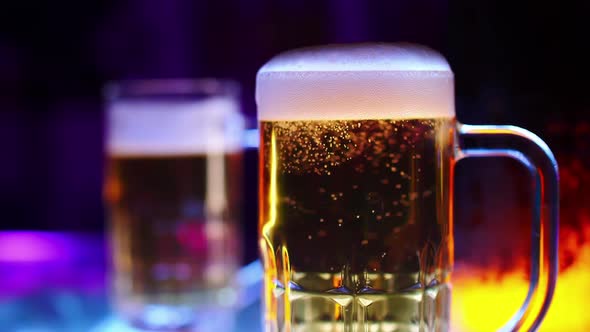 Mug of light beer on the bar counter at a pub party.