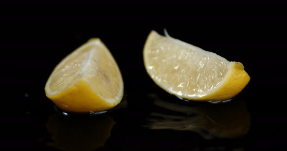 Pieces of Lemon Falling Into the Water