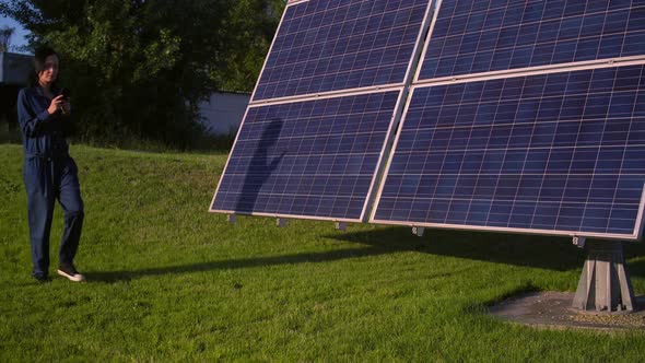 Solar Park Worker Walks Along the Array