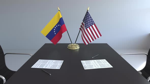 Flags of Venezuela and the United States on the Table