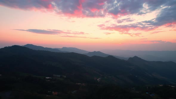 4K Aerial view over mountain scenery at rural Thailand at sunset