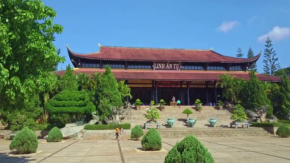 Drone Shows Temple Frontal View Among Trees Bushes