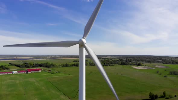 Aerial Pan Left: Close View of Windmill Producing Renewable Energy