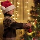 Happy Smiling Boy Decorating Christmas Tree with Red Bauble - VideoHive Item for Sale
