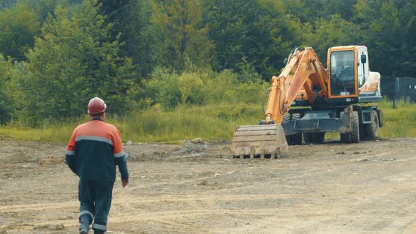 The Driver of the Excavator Goes To the Special Vehicle. An Employee Who Goes To the Excavator