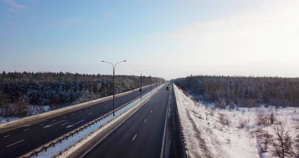 Highway Road with Traffic Cars and Trucks on the Road in Winter