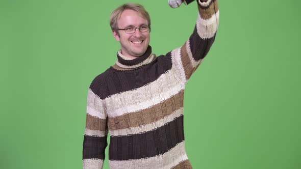 Studio Shot of Happy Handsome Man As Host with Microphone