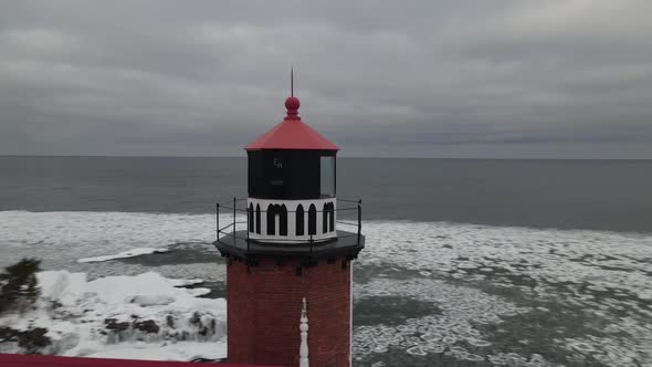 Eagle Harbor, Michigan lighthouse in winter along Lake Superior. 4k drone video.