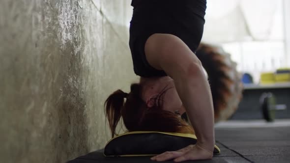 Woman Performing Handstand Push-Ups